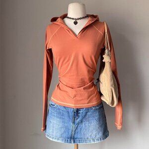 Orange hooded long sleeve top with contrast stitching details